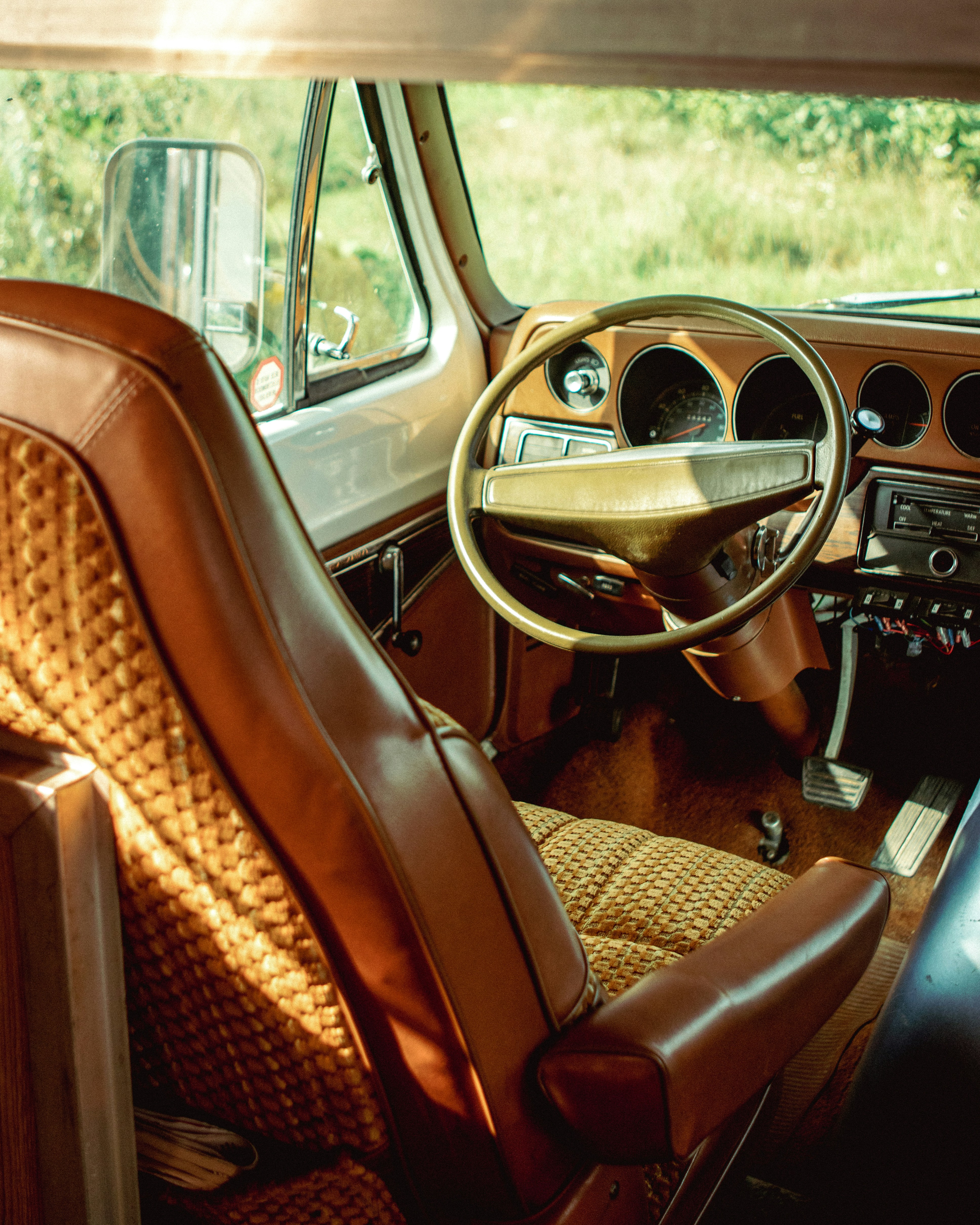 the interior of a car with a steering wheel and dashboard