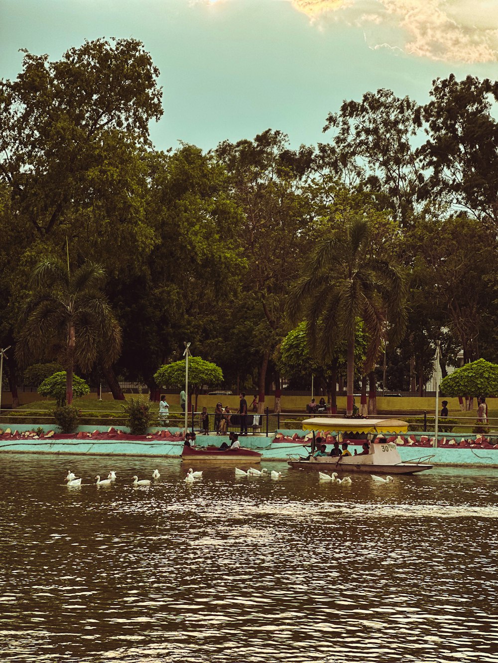 a group of people riding boats on top of a lake