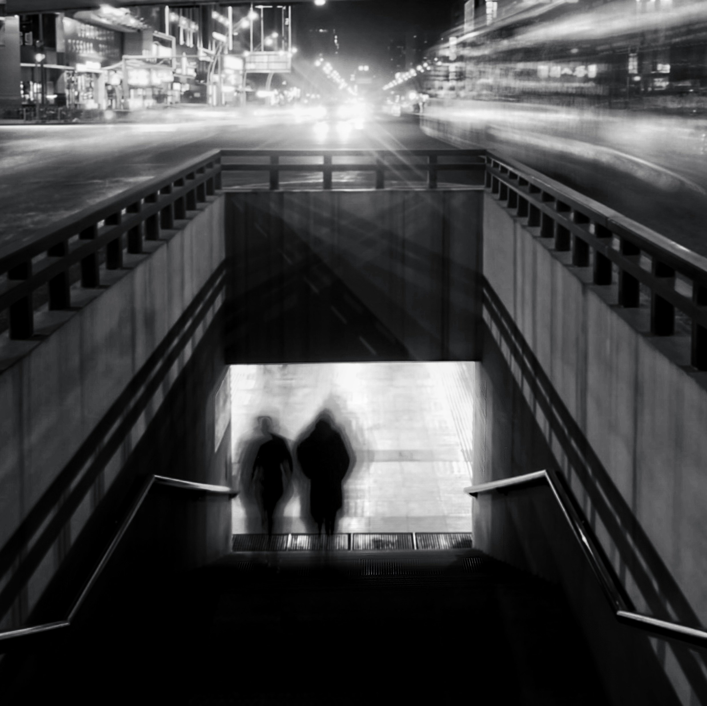 a couple of people walking down a set of stairs