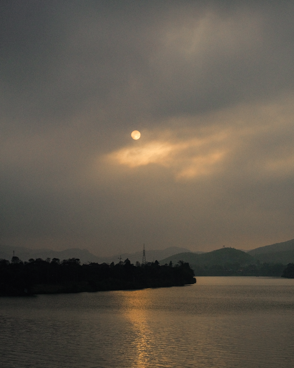 a large body of water under a cloudy sky