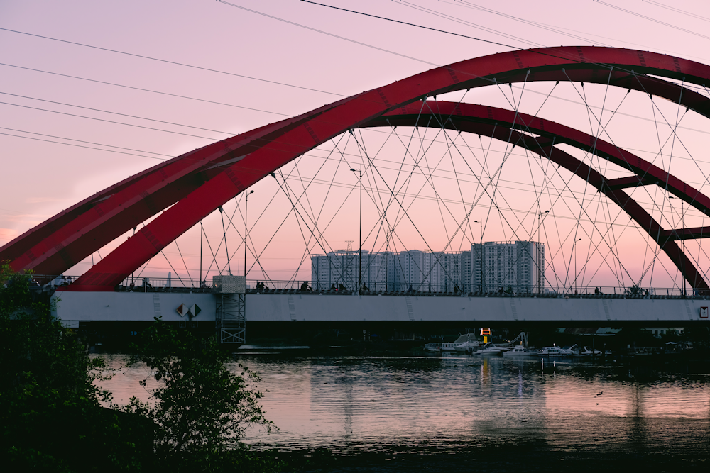 a red bridge over a body of water