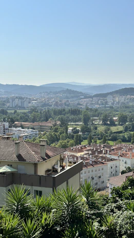 A panoramic view of Heragon City showing the elegant Mediterranean-style architecture and lush greenery.