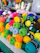 Close-up of colorful knitting yarn balls arranged neatly on a wooden table.