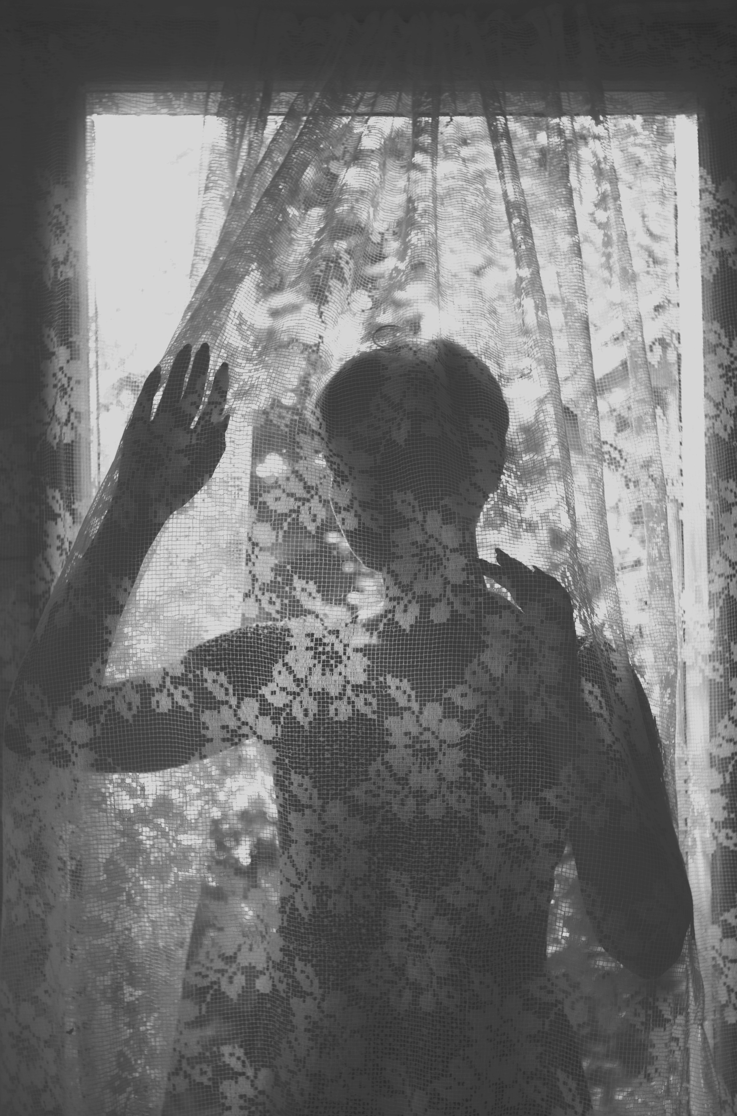 A woman standing in front of a window photo – Free Portrait Image on ...