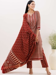 a woman wearing a red and white printed dress