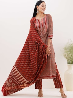 a woman wearing a red and white printed dress