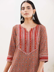 A graceful model wearing a handloom kurti with subtle gold accents against a cream backdrop.