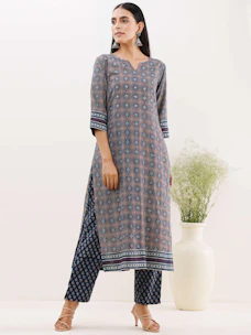 Stylish woman wearing a comfortable kurti in a bright sunny outdoor setting.