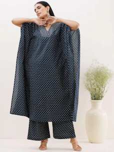 Classic navy blue velvet dress with a fitted waist and elegant draping, styled on a minimalist stand.