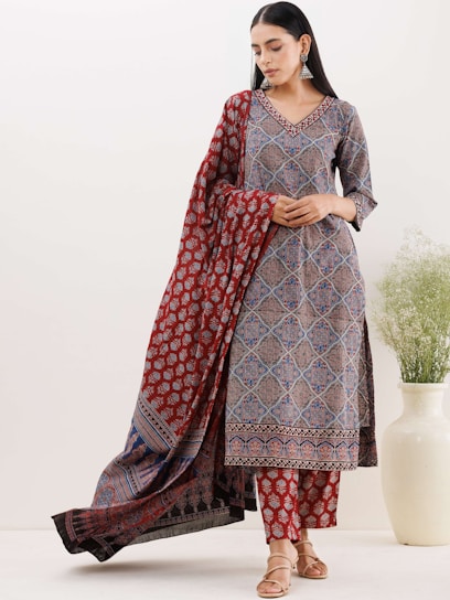 A stylish woman wearing traditional Pakistani attire showcasing vibrant fabrics.