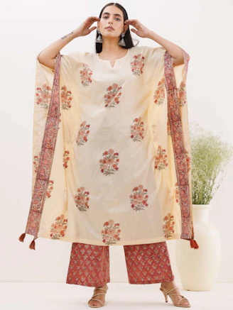 Festive wear ensemble featuring cream and gold accents with subtle lotus motifs.