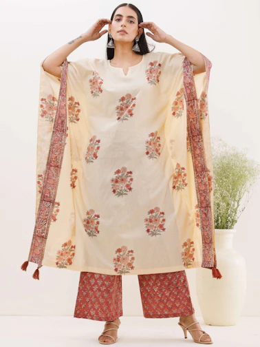 Festive wear ensemble featuring cream and gold accents with subtle lotus motifs.