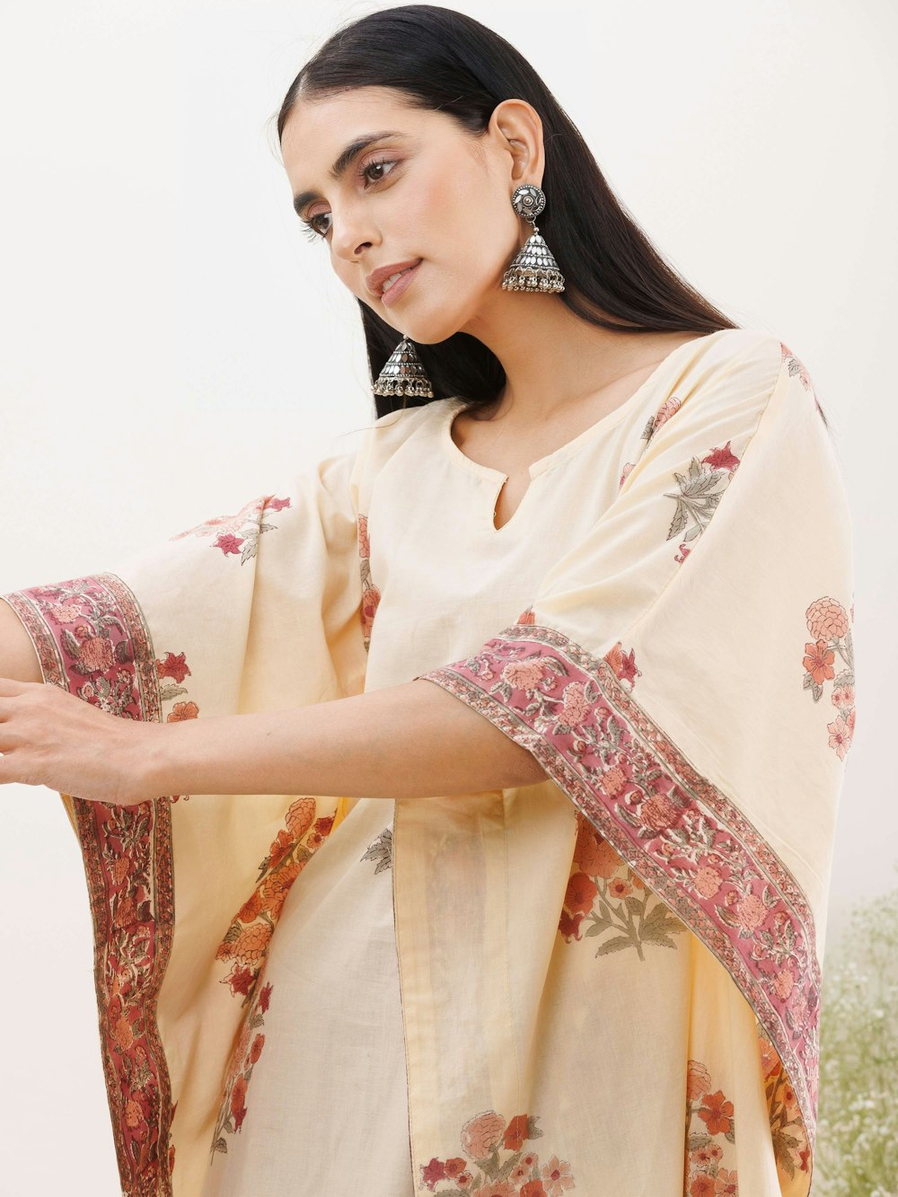 a woman wearing a white and red sari