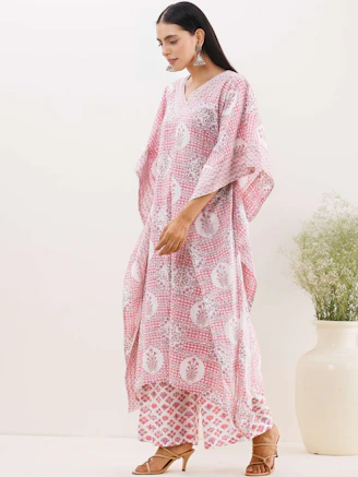 A stylish woman wearing soft viscose leggings and palazzo pants in a sunlit room.