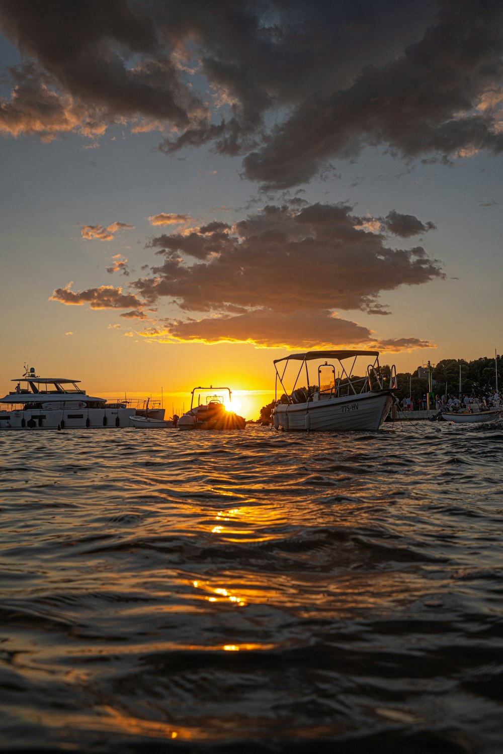 a group of boats floating on top of a body of water