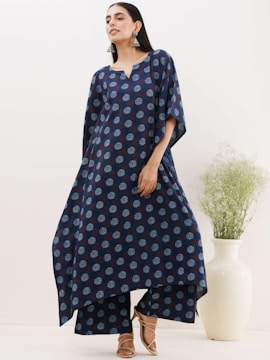 Model wearing a sleek, colorful kokoropo dress standing against a neutral background.