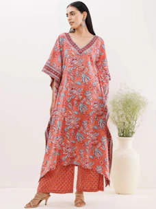 A fresh new arrival ensemble with modern cuts and soft fabric in muted orange and white hues.