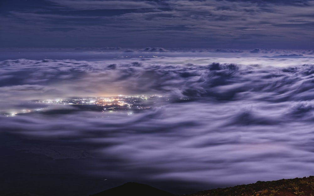 a night view of a city in the clouds
