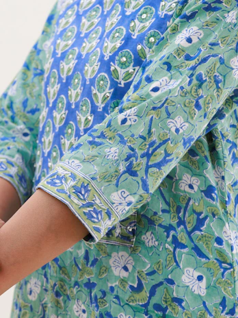 Close-up of delicate floral prints on a lightweight blouse, capturing texture and color.