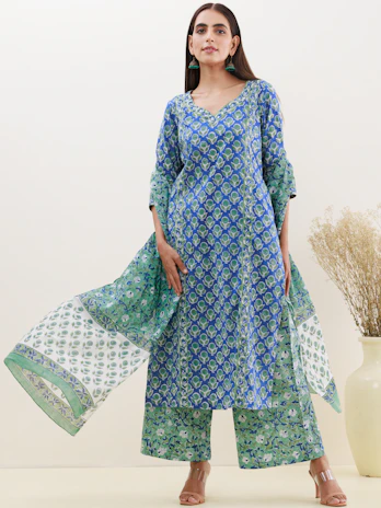 A model wearing a chic, contemporary kurta with subtle ethnic patterns, smiling confidently.