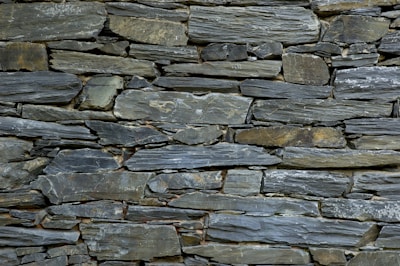 Natural green slate slabs laid out on the ground, showing texture and color variations.