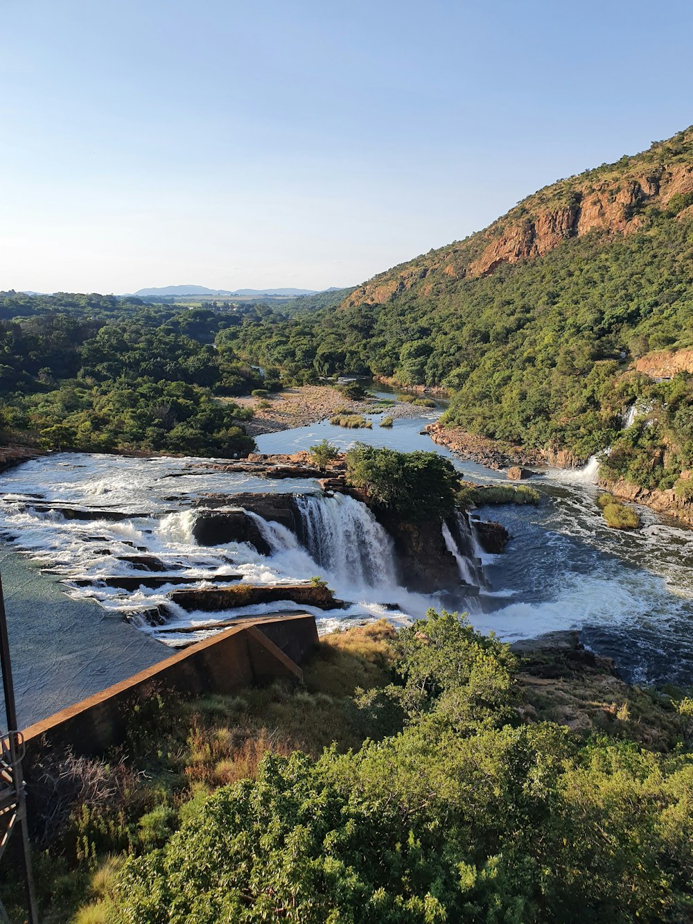 a river with a waterfall in the middle of it