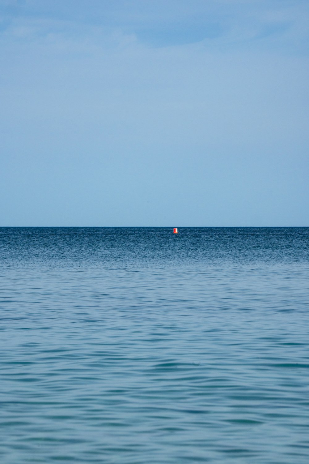 a small boat in the middle of a large body of water