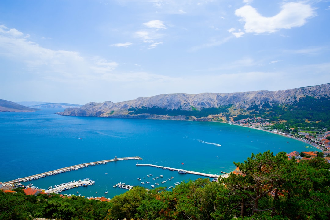 a large body of water surrounded by mountains,