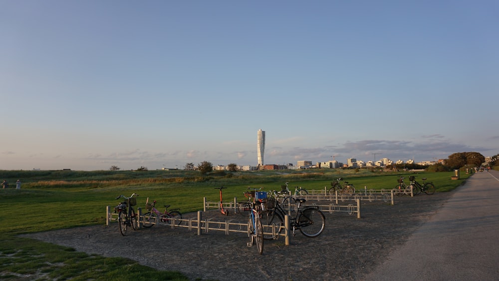 a group of bikes parked next to a wooden fence