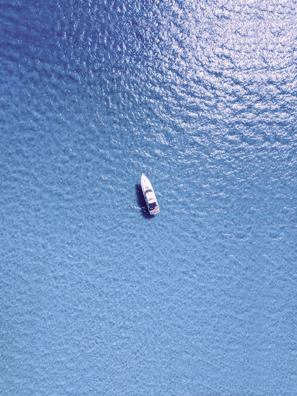 a small boat floating in a large body of water