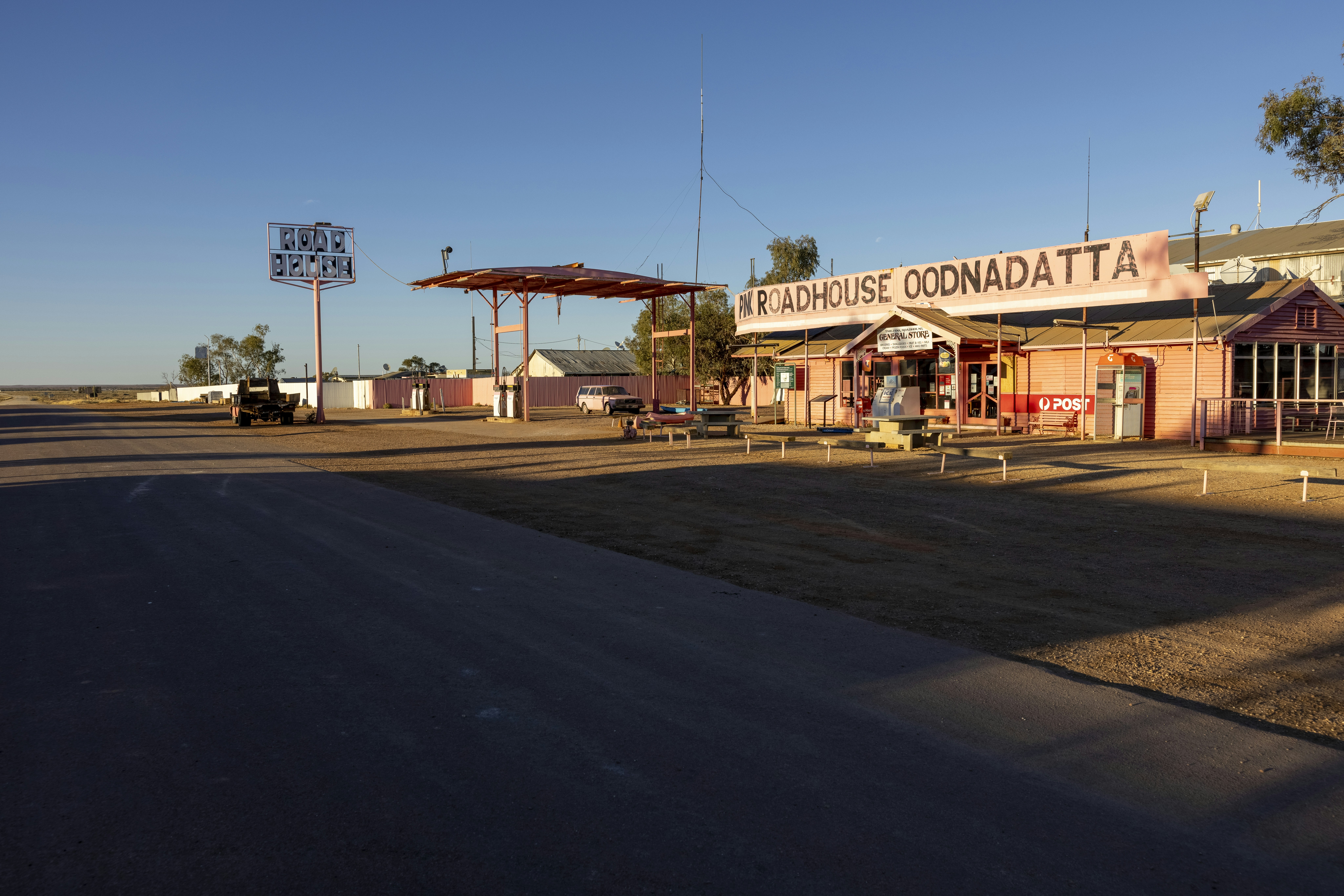 a small town with a gas station in the background