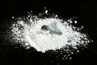 Workers inspecting micronized calcite powder in a quality control lab