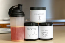 Dynamic shot of creatine supplement jar with green lime accents on a dark background