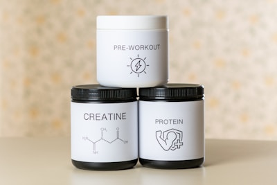 three jars of cream sitting on top of a table