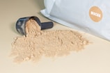a scoop of powder next to a bag of powder