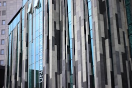 Elegant commercial building facade featuring ACM panels and large glass windows.