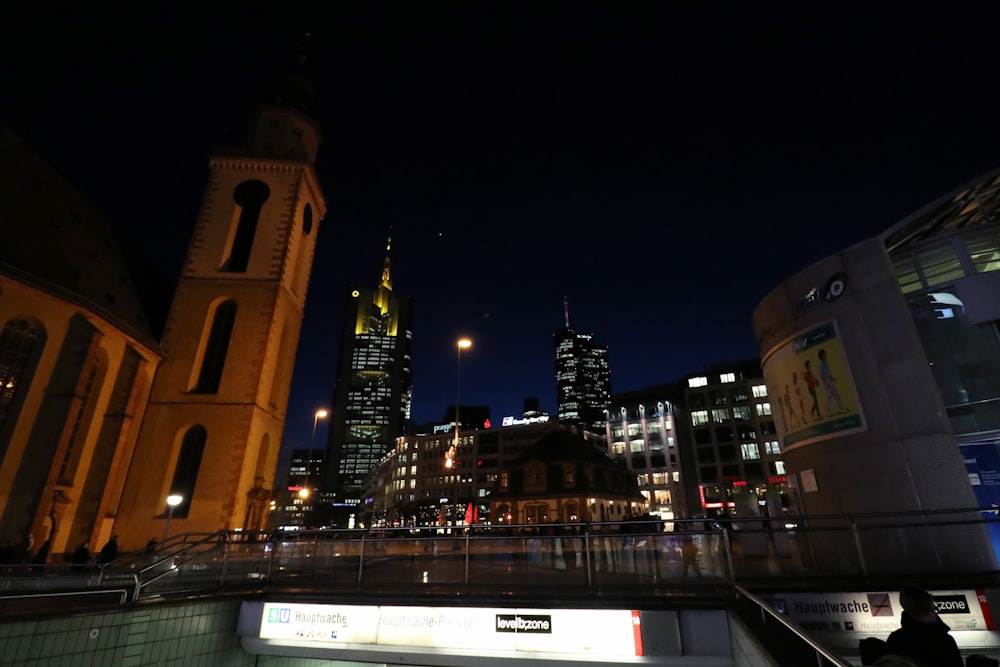 a view of a city at night from an escalator