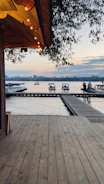 Evening shot of a lakeside deck with soft lighting and natural wood finishes.
