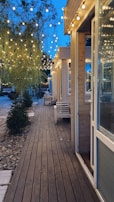 An inviting outdoor deck with wood accents and subtle lighting, perfect for evening gatherings.