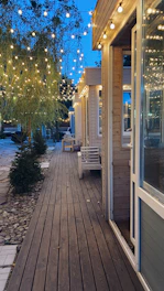 Elegant spacious cedar deck with built-in seating and evening lighting in a Vancouver backyard.