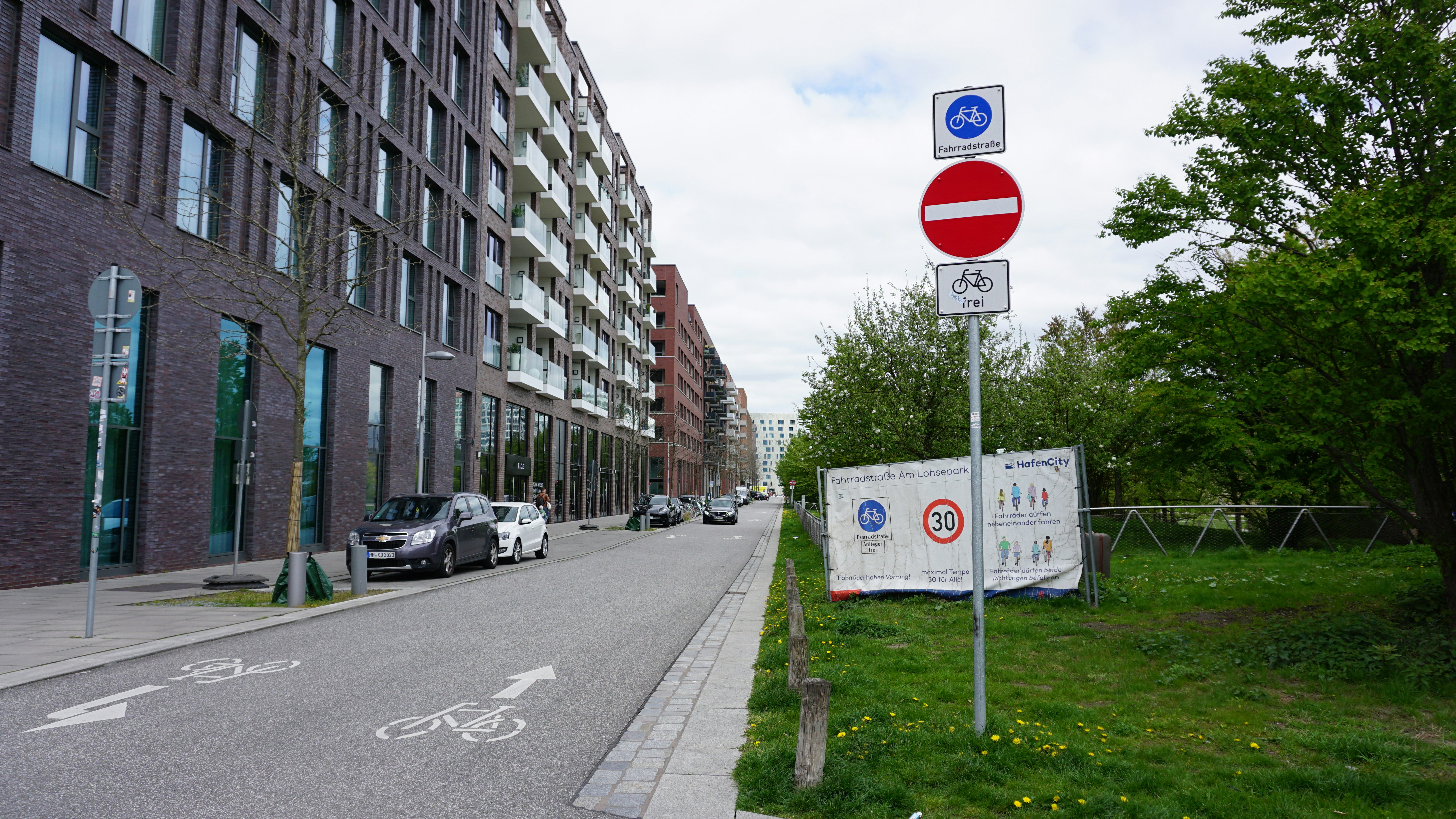 a red and white street sign sitting on the side of a road