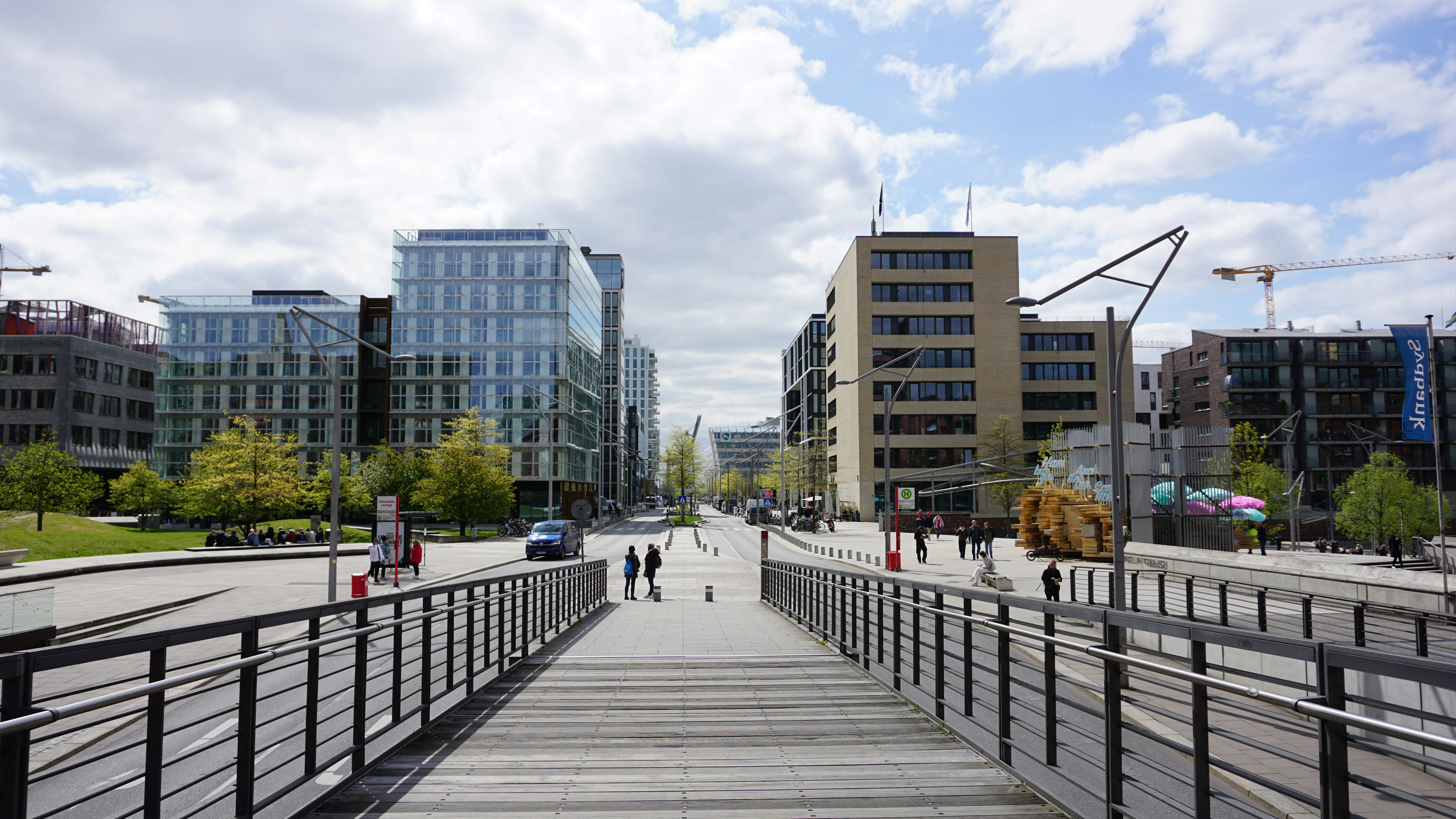 a long wooden walkway with people walking on it