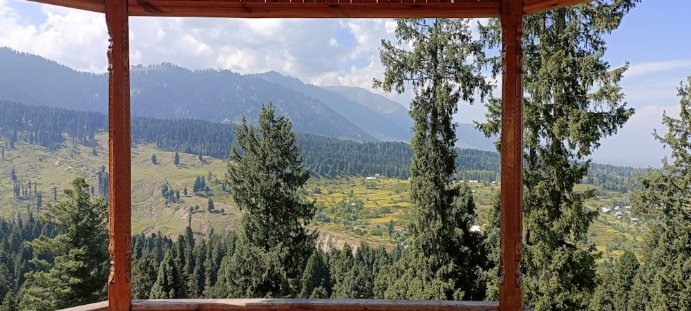 a gazebo with a view of a valley and mountains
