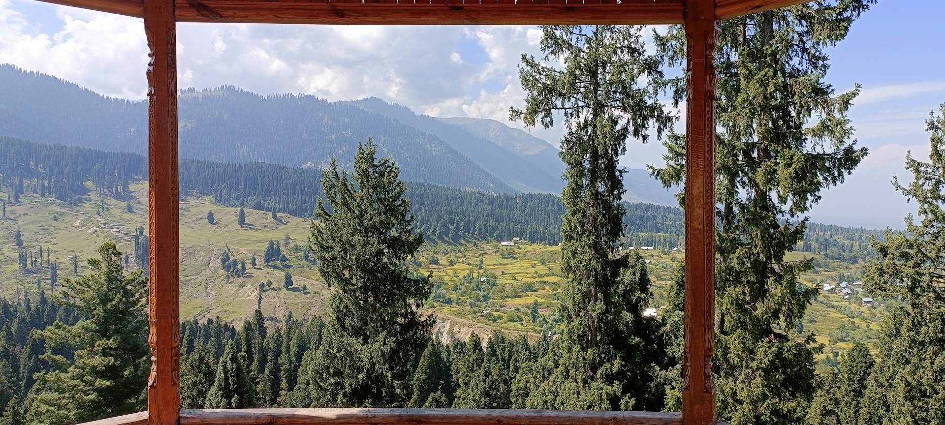 a gazebo with a view of a valley and mountains