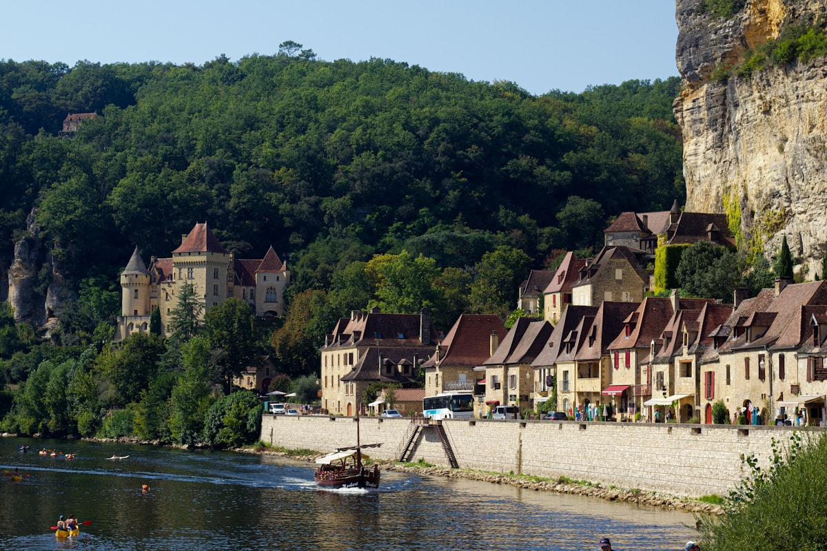 Canoes on the Dordogne River beneath the medieval castle of Beynac