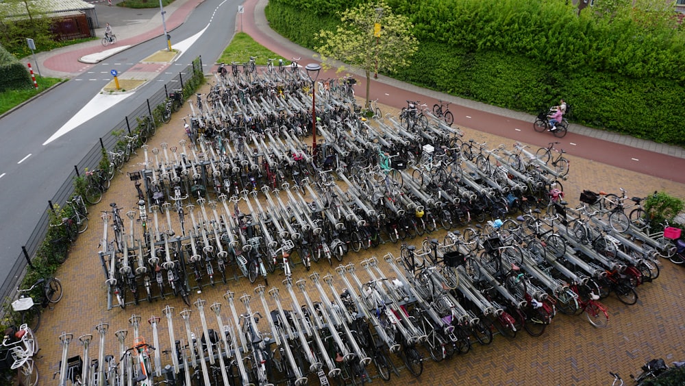 a large amount of bicycles parked in a parking lot