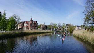 People practicing stand-up paddleboarding on the calm, crystal-clear waters of Canal do Itajuru.