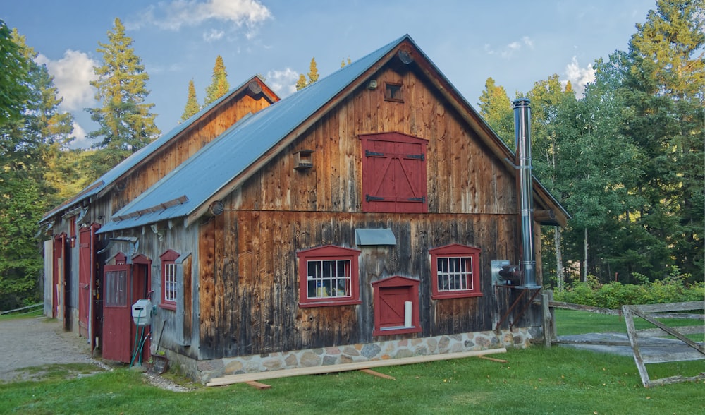 a barn with red shutters and a blue roof