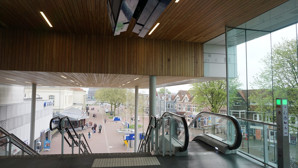 an escalator in a building with a view of a street