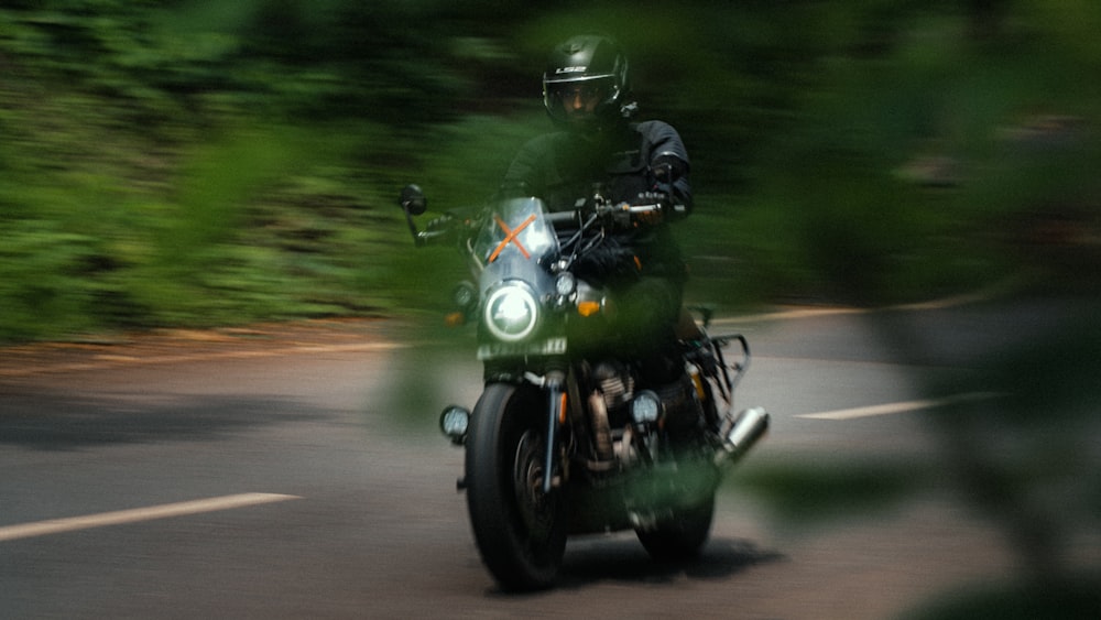 a man riding a motorcycle down a curvy road